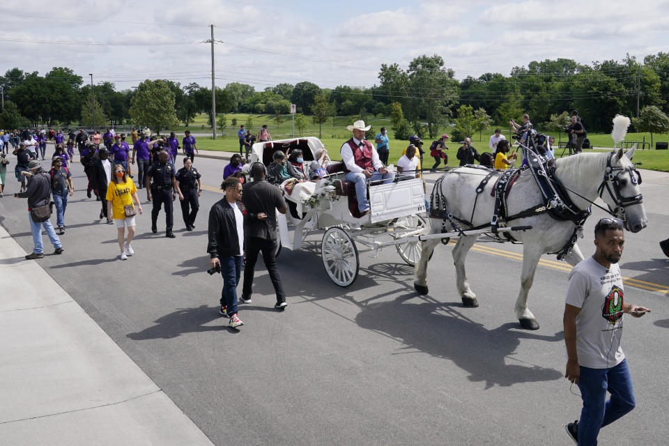 Tulsa race massacre survivors Hughes Van Ellis Sr., left, Lessie Benningfield Randle, center, and Viola Fletcher, right, ride in a horse drawn carriage during a march Friday, May 28, 2021, in Tulsa, Okla. (AP Photo/Sue Ogrocki)