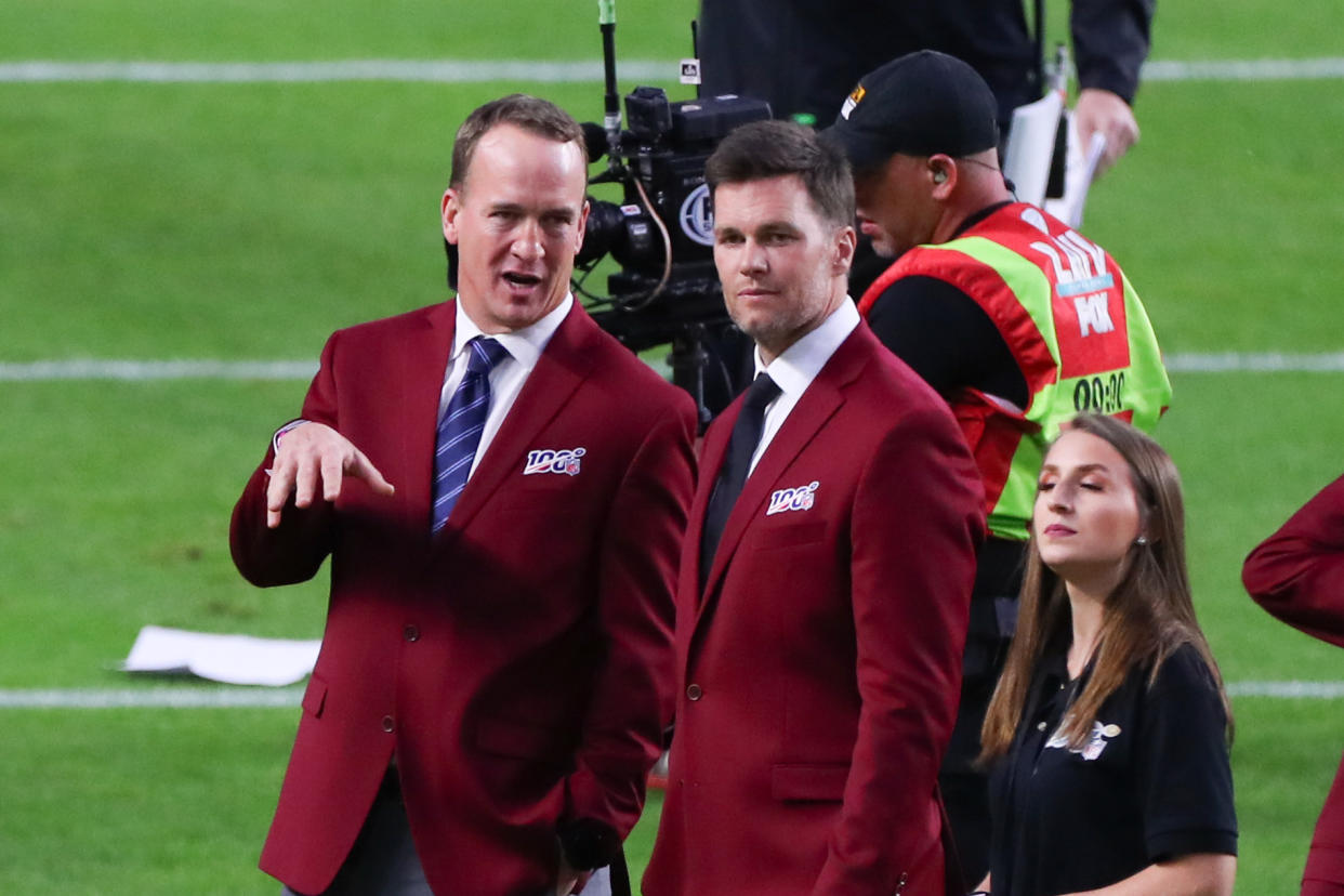 MIAMI GARDENS, FL - FEBRUARY 02: Tom Brady and Peyton Manning talk on the field during the 100 year team celebration prior to Super Bowl LIV on February 2, 2020 at Hard Rock Stadium in Miami Gardens, FL.  (Photo by Rich Graessle/PPI/Icon Sportswire via Getty Images)