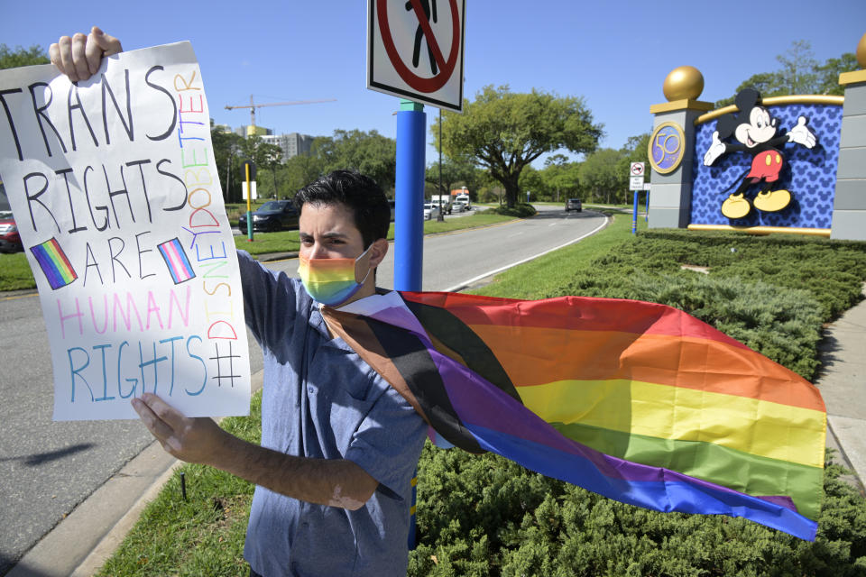 FILE - Disney cast member Nicholas Maldonado protests the company's stance on LGBTQ issues, while participating in an employee walkout at Walt Disney World on March 22, 2022, in Lake Buena Vista, Fla. For many of those who live in Florida, recent months in 2023 have brought some changes — many linked to Gov. Ron DeSantis. “Don’t say gay.” Regulation of books and classroom discussion. Teachers, parents and school librarians are all navigating new and uncertain ground. LGBTQ+ rights under attack. A very public spat between the state government and Disney. And at the center of it all is DeSantis, who has emerged as a rival of former President Donald Trump and likely has his eyes set on the White House. (AP Photo/Phelan M. Ebenhack, File)