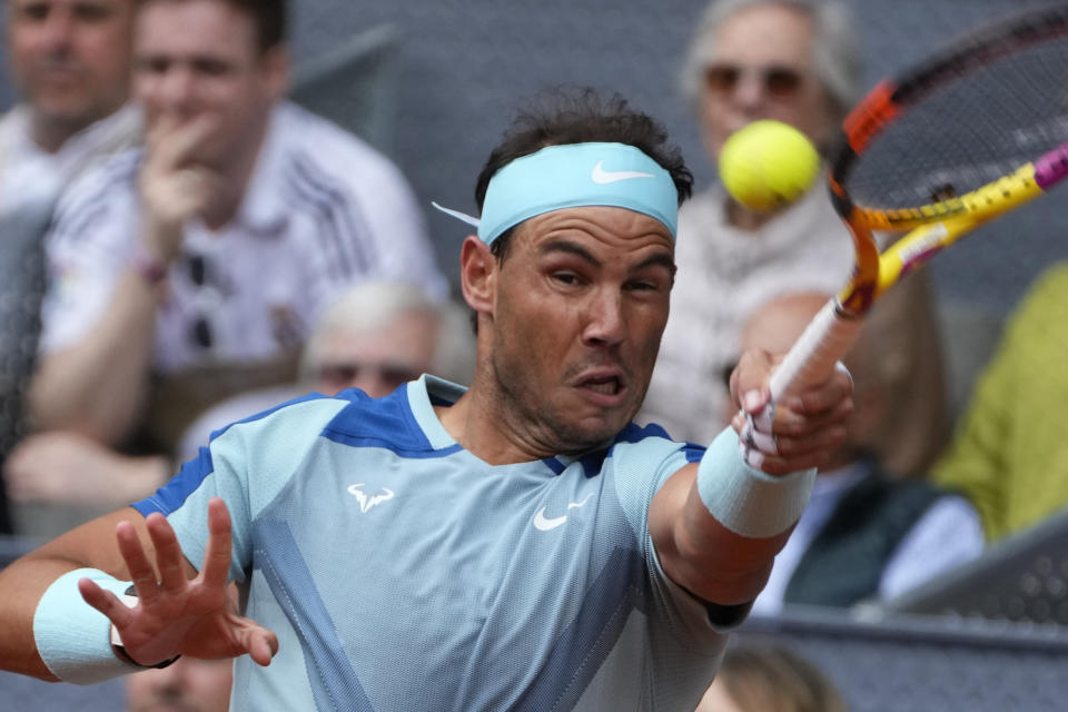 Rafael Nadal of Spain returns the ball to Miomir Kecmanovic of Serbia during their match at the Mutua Madrid Open tennis tournament in Madrid, Spain, Wednesday, May 4, 2022. (AP Photo/Paul White)