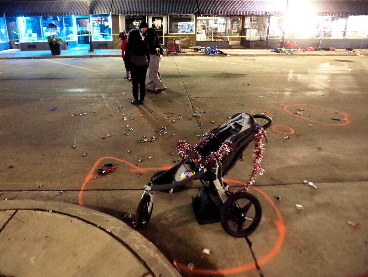 A broken children's stroller lays on W. Main St. in downtown Waukesha, Wis., after an SUV drove into a parade of Christmas marchers Sunday, Nov. 21, 2021. The trial of Darrell Brooks Jr.  accused of driving his SUV through a Christmas parade in suburban Milwaukee, killing six people and wounding many more, was never going to be easy for the people who lived through it. Now it may be worse, after Brooks Jr. was allowed to dismiss his attorneys and represent himself.  (John Hart/Wisconsin State Journal via AP)