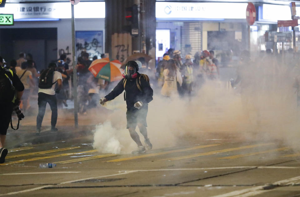 Police use tear smoke at protestors in Hong Kong, Sunday, Sept. 29, 2019. Protesters and police clashed in Hong Kong for a second straight day on Sunday, throwing the city's business and shopping belt into chaos and sparking fears of more ugly scenes leading up to China's National Day this week. (AP Photo/Vincent Thian)