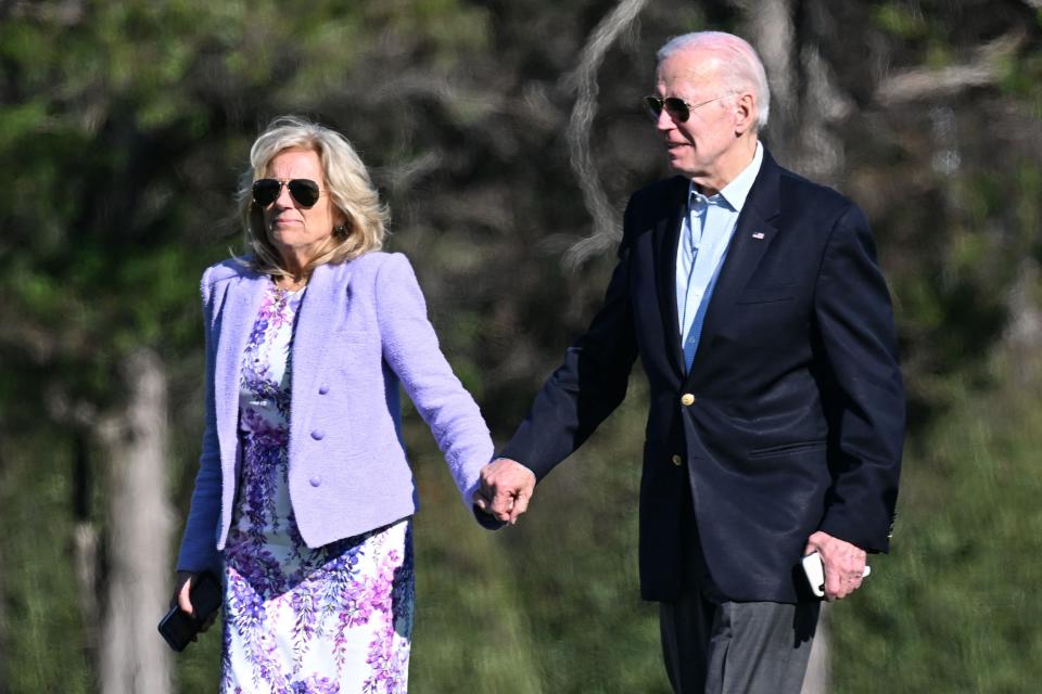 US President Joe Biden, and First Lady Jill Biden, walk to the motorcade after arriving on Marine One at Fort McNair in Washington, DC on April 9, 2023.