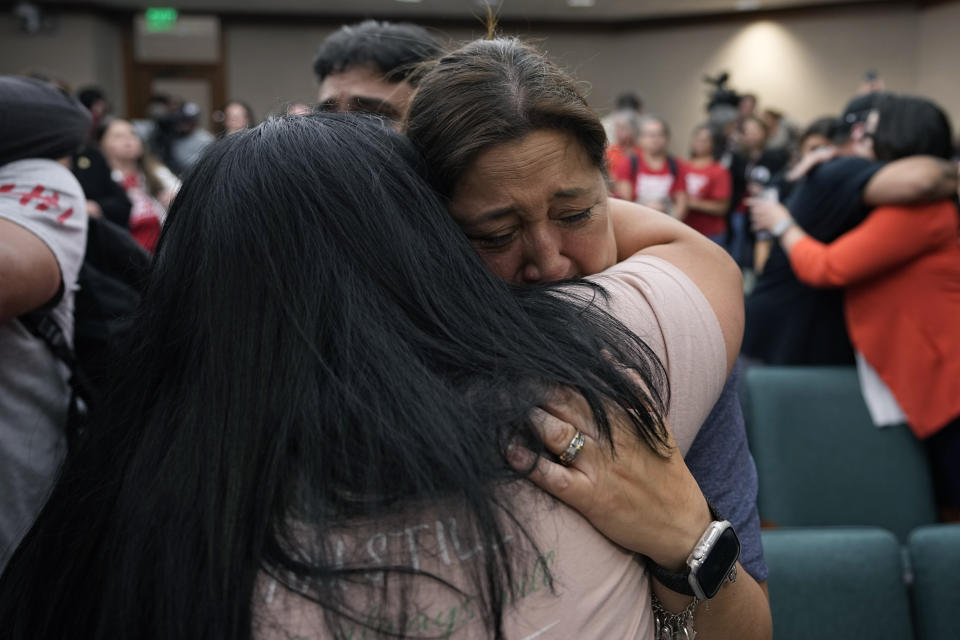 FILE - Veronica Mata, right, and other family members of the victims of the Uvalde shootings react after a Texas House committee voted to take up a bill to limit the age for purchasing AR-15 style weapons in the full House in Austin, Texas, Monday, May 8, 2023. Families in Uvalde, Texas, are digging in for a new test of legal protections for the gun industry as they mark one year since the Robb Elementary School shooting. Both the U.S. government and gun manufacturers in recent years have reached large settlements following some of the nation's worst mass shootings. (AP Photo/Eric Gay, File)