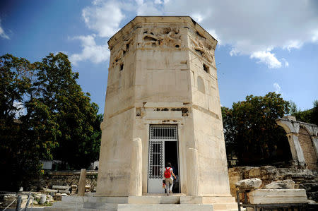 Tourists visit the Tower of the Winds, open to the public for the first time in more than 200 years after being restored, in the Roman Agora, in Plaka, central Athens, Greece, August 23, 2016. Picture taken August 23, 2016. REUTERS/Michalis Karagiannis