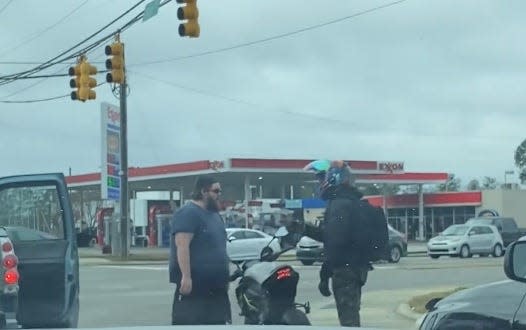 A still from a cellphone video that captured the shooting death of Stephen Addison, shows Addison, right, seconds  before police say he was shot by the driver of the pickup truck in the left of the photo.