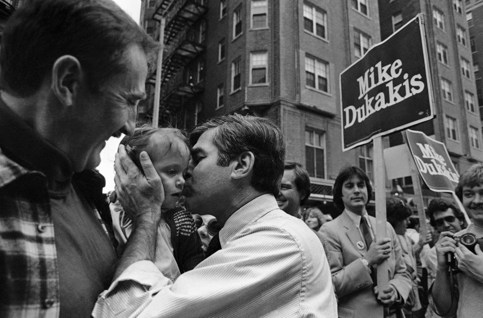 FILE - This photo by Elise Amendola shows Democratic gubernatorial hopeful Mike Dukakis kissing Larissa Srhyroky, 14-months, as he campaigned, Sunday, Sept. 27, 1982 in Boston. Amendola, who recently retired from the AP, died Thursday, May 11, 2023, at her home in North Andover, Mass., after a 13-year battle with ovarian cancer. She was 70. (AP Photo/Elise Amendola, File)