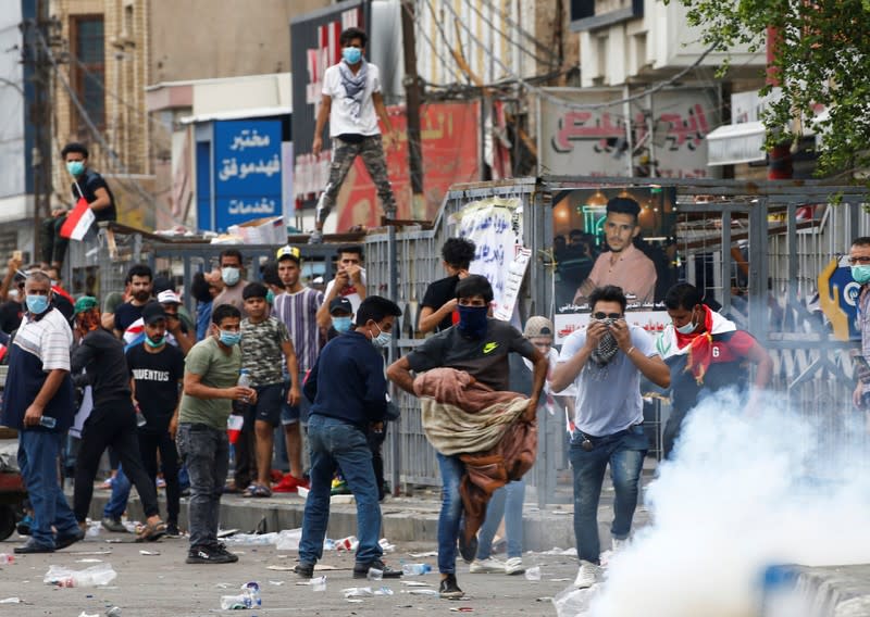 Demonstrators disperse as Iraqi Security forces use tear gas during a protest over corruption, lack of jobs, and poor services, in Baghdad