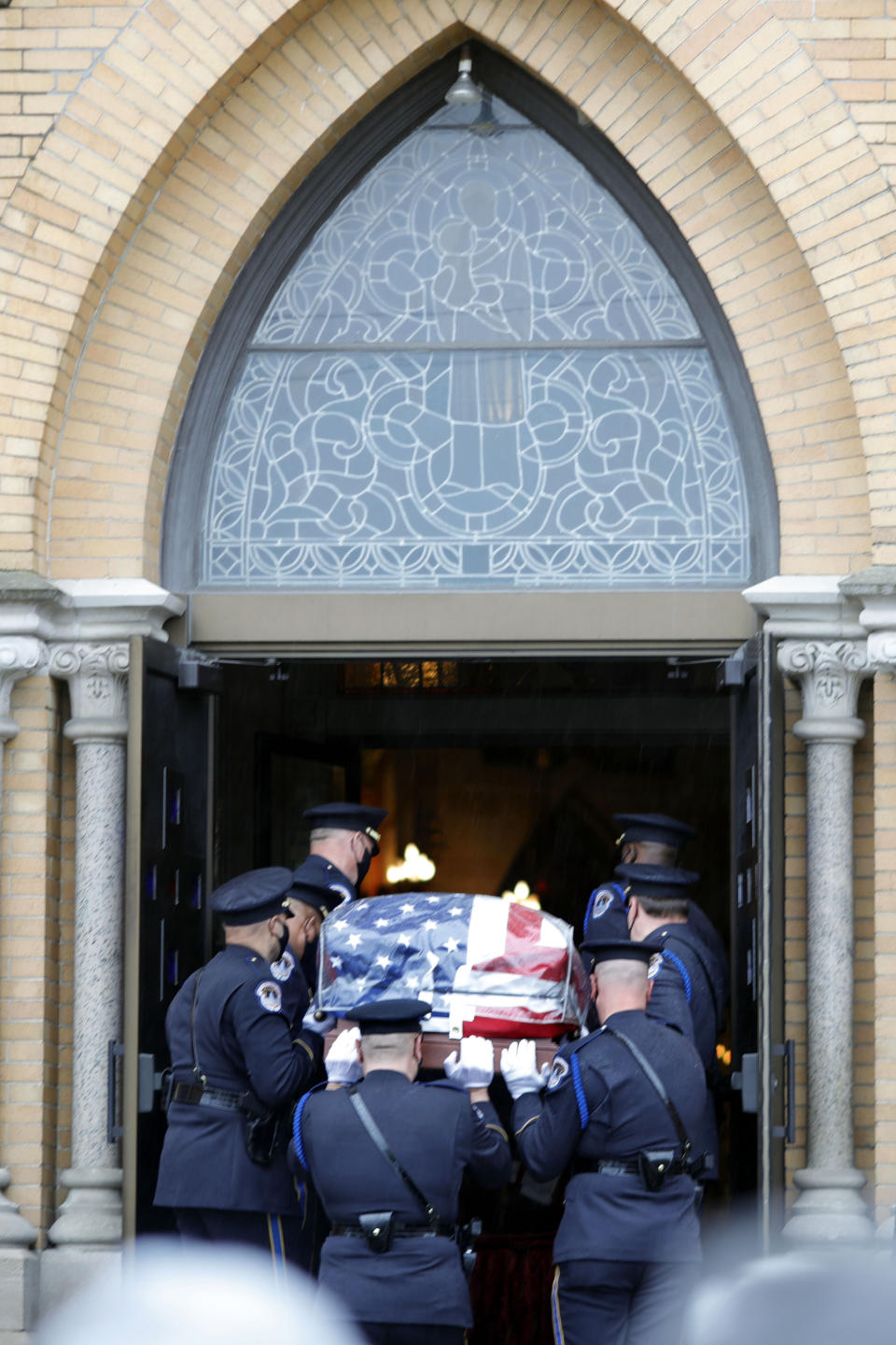 Capitol Police Officers carry the casket of their fellow officer, the late William "Billy" Evans into St. Stanislaus Kotska Church in Adams, Mass., for his funeral on Thursday, April 15, 2021. Evans was killed this month when a driver struck him and another officer at a barricade outside the Senate. (Stephanie Zollshan/The Berkshire Eagle via AP)