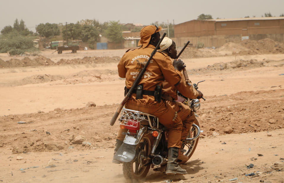 Local defense force fighters drive on a motorbike during an event to inaugurate a new chapter of the group in Ouagadougou, Burkina Faso, Saturday, March 14, 2020. In an effort to combat rising jihadist violence, Burkina Faso’s military has recruited volunteers to help it fight militants. (AP Photo/Sam Mednick)