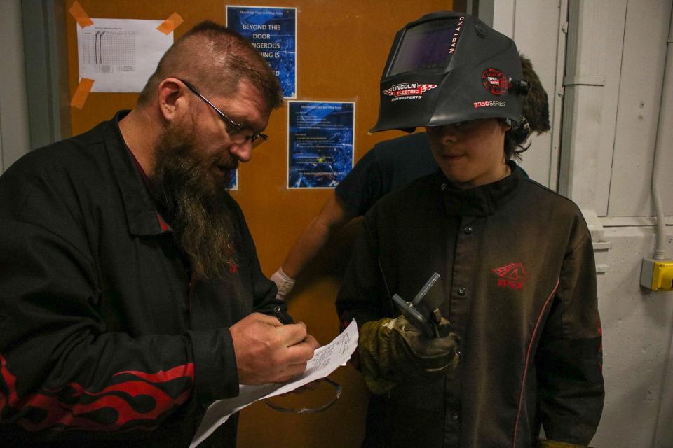 Cole Dow (left) grades Dalton Sawyer's weld in class Nov. 8.