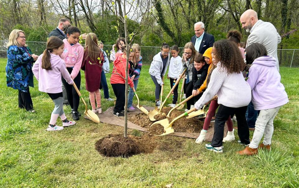 City of Oak Ridge officials join Glenwood Elementary School's Cub Choir of third- and fourth-grade students to plant a tulip poplar April 5, 2024 for Arbor Day.