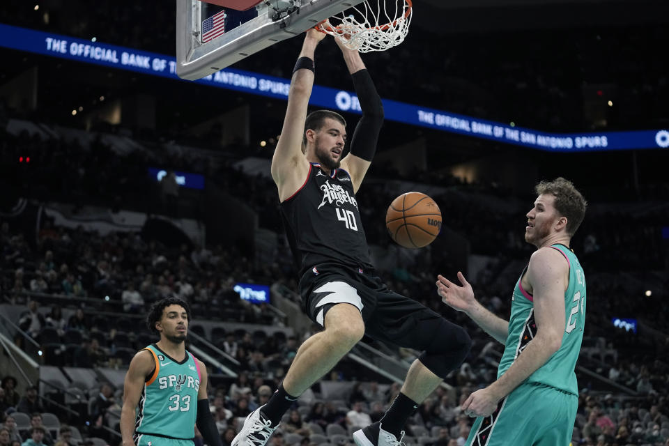 Los Angeles Clippers center Ivica Zubac (40) scores next to San Antonio Spurs center Jakob Poeltl (25) during the second half of an NBA basketball game in San Antonio, Friday, Jan. 20, 2023. (AP Photo/Eric Gay)