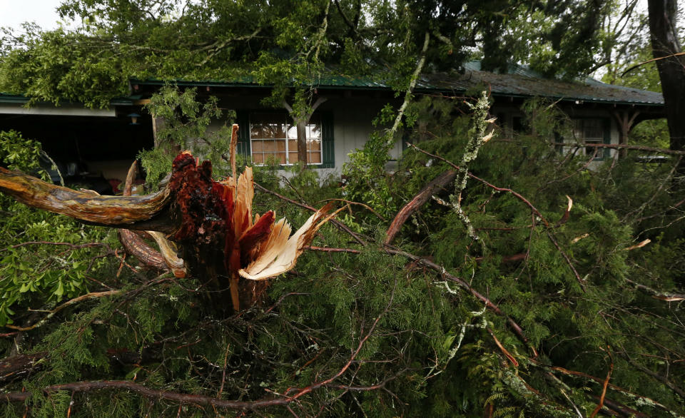 Ripped tree branches litter a Learned, Miss., home, following severe weather that hit the small community, Thursday, April 18, 2019. Several homes were damaged by fallen trees in the tree lined community. Strong storms again roared across the South on Thursday, topping trees and leaving more than 100,000 people without power across Mississippi, Louisiana and Texas. (AP Photo/Rogelio V. Solis)
