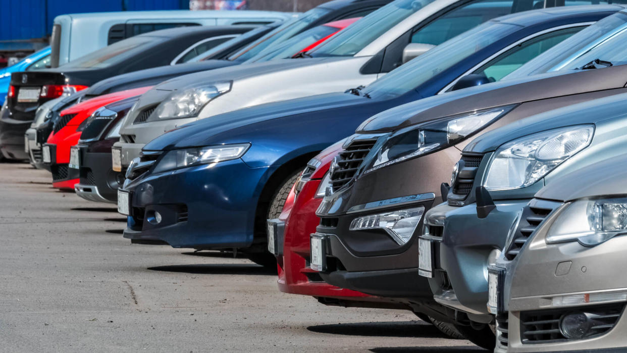 View of the front of the cars parked in a row in the city Parking lot.