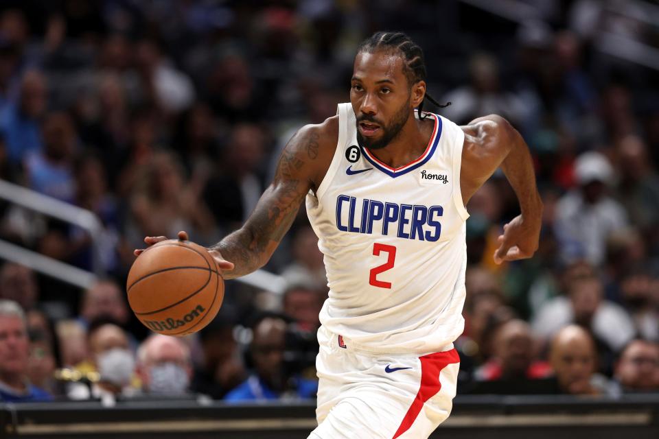 FILE - Los Angeles Clippers forward Kawhi Leonard dribbles down the court during the first half of a preseason NBA basketball game against the Minnesota Timberwolves, Oct. 9, 2022, in Los Angeles. Leonard and Paul George are healthy again heading into their fourth season together, raising the Clippers' hopes of winning the franchise's first championship sky-high. (AP Photo/Raul Romero Jr., File)