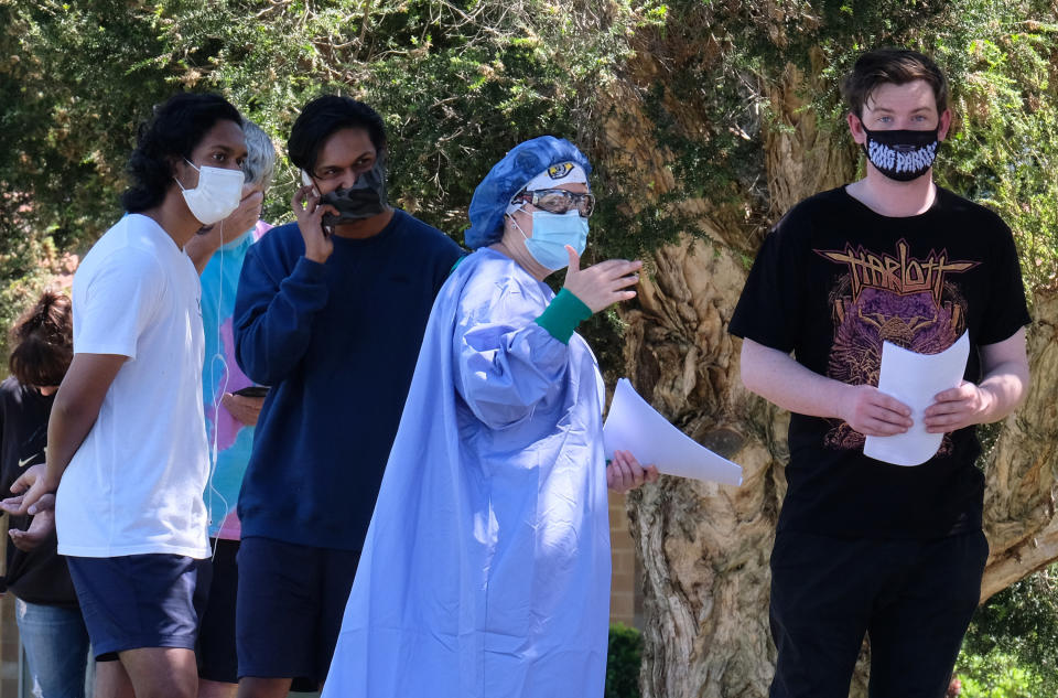 People line up as they wait to be tested for Covid-19 at the Sunbury Respiratory Clinic in Melbourne.