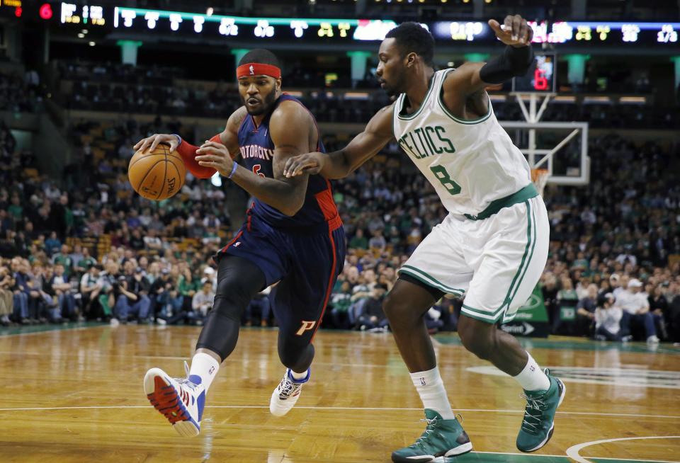 Detroit Pistons' Josh Smith (6) drives past Boston Celtics' Jeff Green (8) in the first quarter of an NBA basketball game in Boston, Sunday, March 9, 2014. (AP Photo/Michael Dwyer)