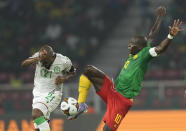 Comoros' El Fardou Ben Nabouhane, left, defends as Cameroon's Vincent Aboubakar controls the ball, during the African Cup of Nations 2022 round of 16 soccer match between Cameroon and Comoros at the Olembe stadium in Yaounde, Cameroon, Monday, Jan. 24, 2022. (AP Photo/Themba Hadebe)