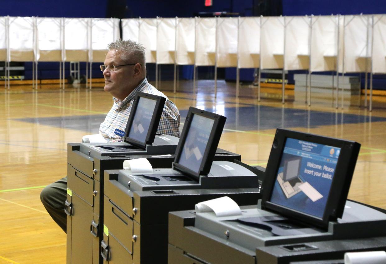 Michael Bracken waits for voters to cast their ballots into the counting machine in York Tuesday, March 5, 2024.