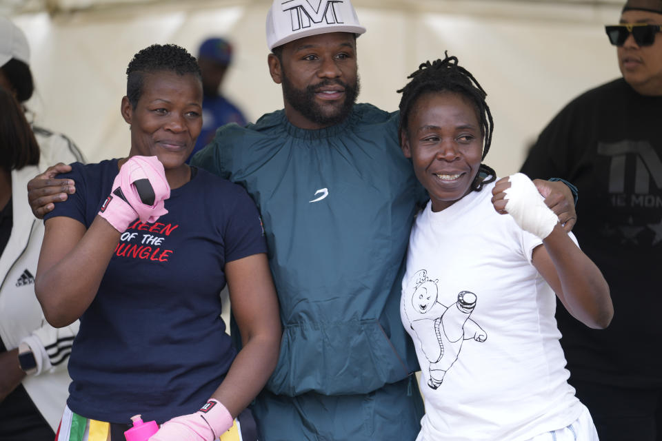U.S boxing promoter and former professional boxer Floyd Joy Mayweather, center, poses for a picture with women boxers at an event on the outskirts of the capital Harare, Zimbabwe Thursday, July 13, 2023. Mayweather is in the country for what he is calling the Motherland Tour. (AP Photo/Tsvangirayi Mukwazhi)