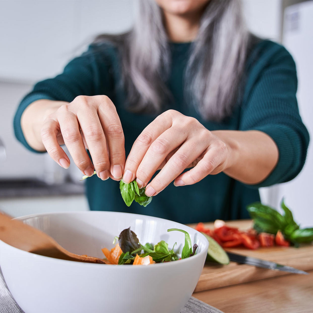 older woman making herself a healthy salad