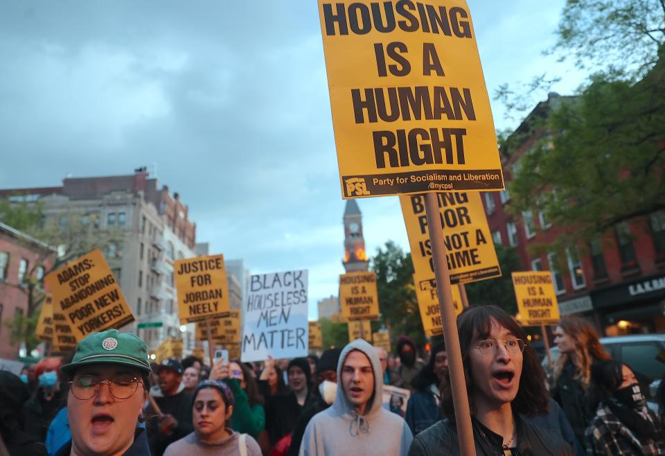 Demonstrators marching to New York City's Washington Square Park on May 5. One holds a sign reading: Housing is a human right.