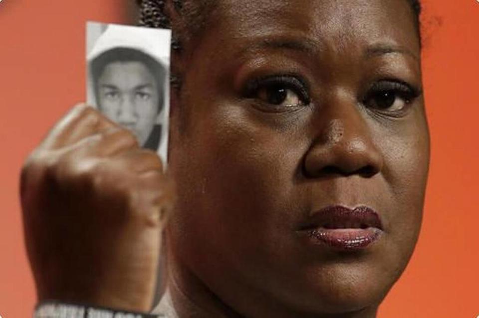 Sybrina Fulton, mother of Trayvon Martin, holds up a card with a photo of her son as she speaks at the National Urban League’s annual conference in Philadelphia in 2013.