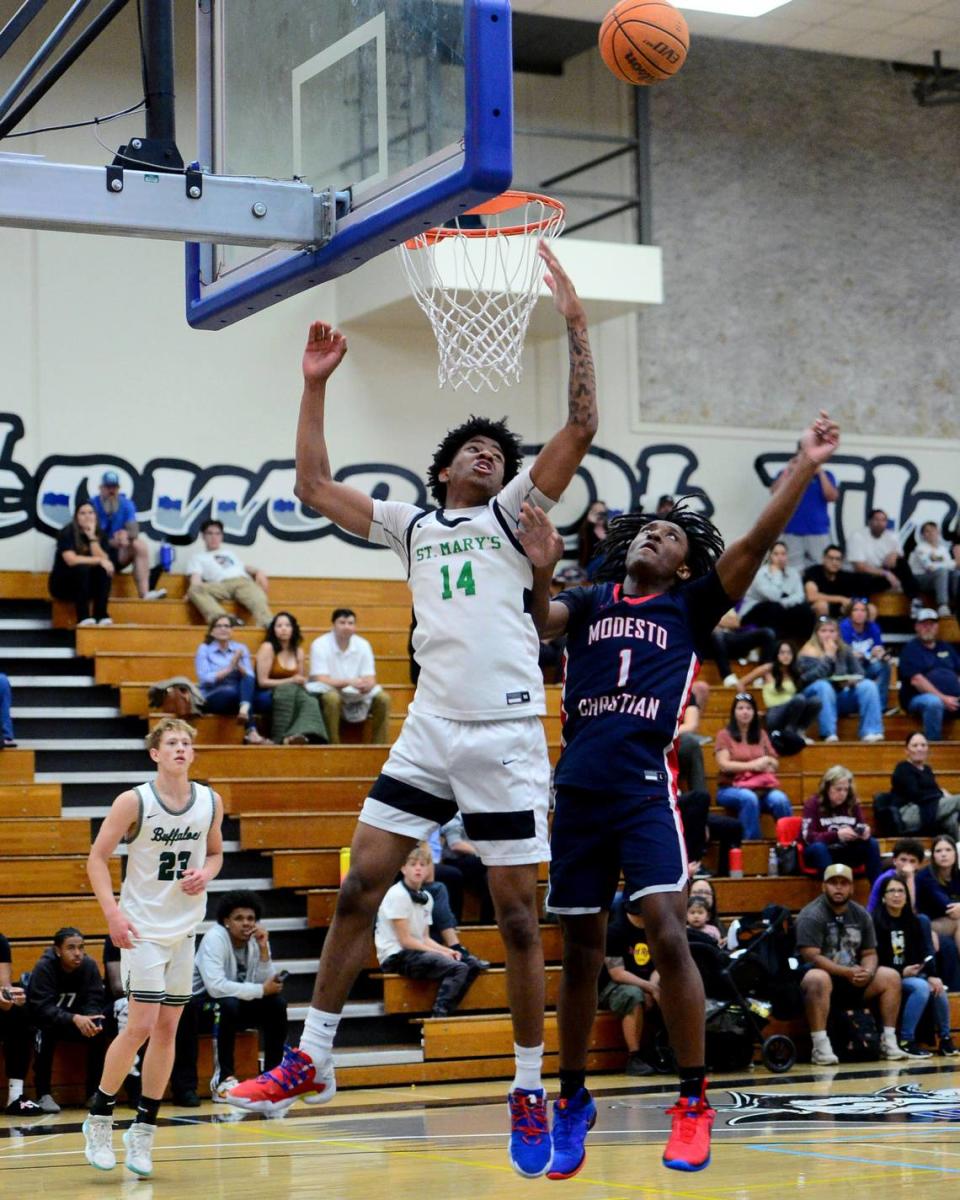 Modesto Christian guard Jeremiah Bernard (1) fights for a rebound with St. Marys Cayden Ward (14) during the 27th Annual Six County All Star Senior Basketball Classic Boys game at Modesto Junior College in Modesto California on April 27, 2024. The Red team beat the Blue team 81-79.