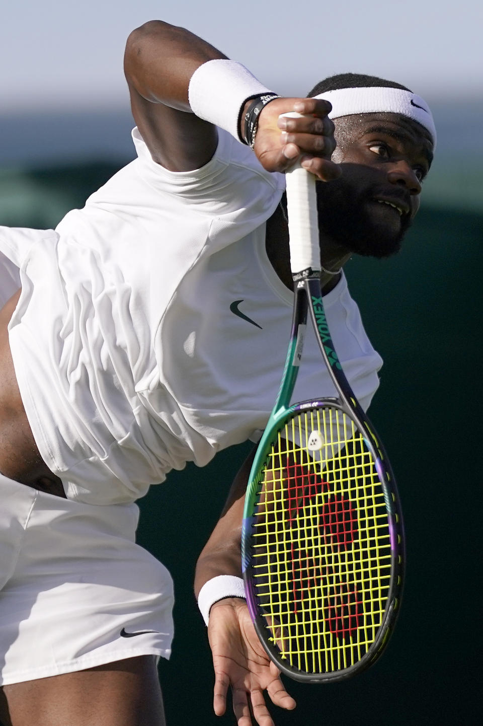 Frances Tiafoe of the US serves to Switzerland's Dominic Stricker in a men's singles match on day four of the Wimbledon tennis championships in London, Thursday, July 6, 2023. (AP Photo/Alberto Pezzali)