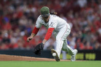 Cincinnati Reds' Luis Castillo fields a ball hit by Los Angeles Dodgers' Trea Turner, who was out at first during the fourth inning of a baseball game in Cincinnati, Friday, Sept. 17, 2021. (AP Photo/Aaron Doster)