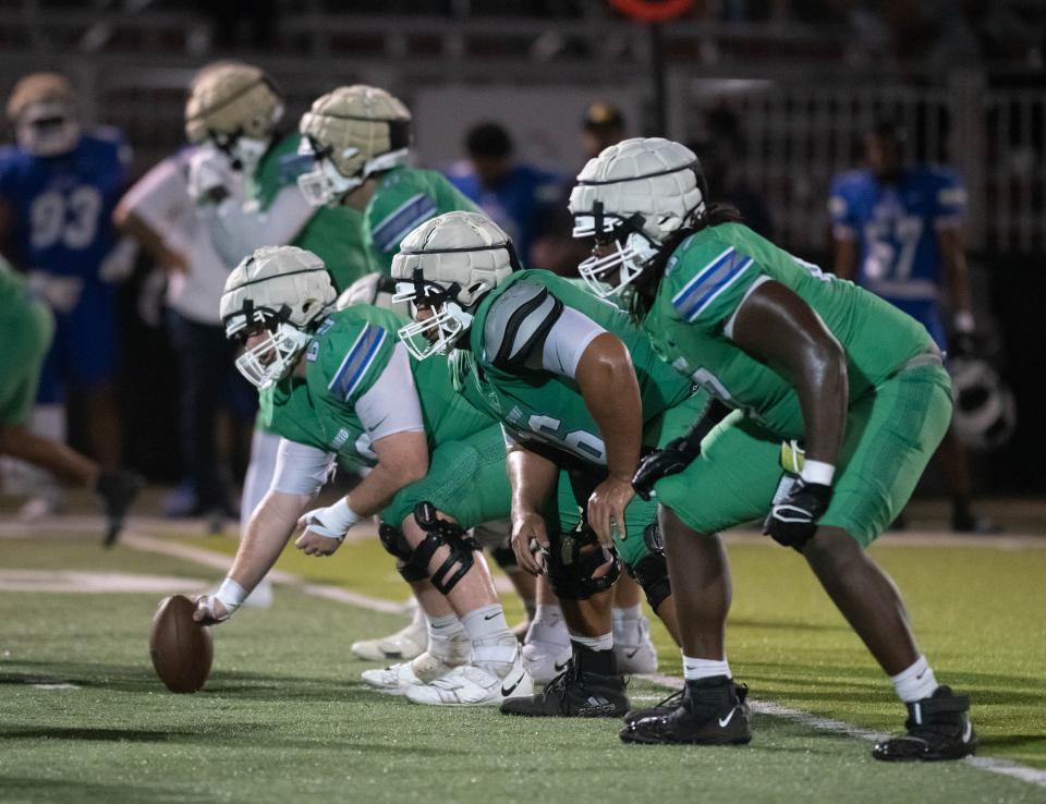 The offensive line gets ready for the snap during the spring football game at the University of West Florida in Pensacola on Thursday, March 9, 2023.