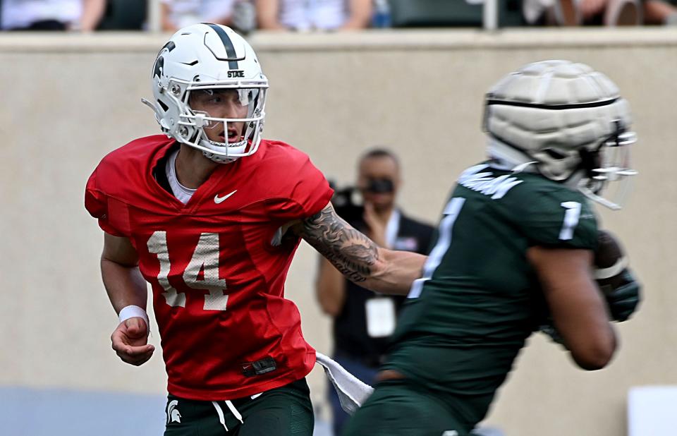 Apr 15, 2023; East Lansing, MI, USA; Michigan State Spartans quarterback Noah Kim (14) hands the ball off at Spartan Stadium.