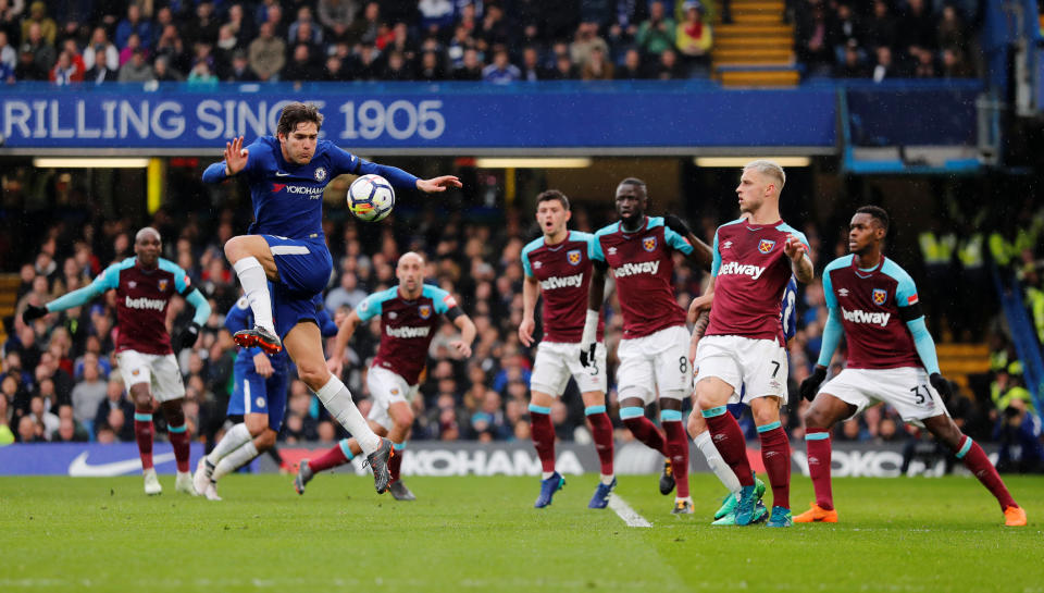 <p>Chelsea’s Marcos Alonso gets a shot away in the first half </p>