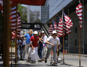 Members of the first U.S. Olympic skateboarding team arrive on their boards for a news conference in downtown Los Angeles on Monday, June 21, 2021. The Olympic skateboarding team was introduced in Southern California, where the sport was invented roughly 70 years ago. Skateboarding is an Olympic sport for the first time in Tokyo, and the Americans are expected to be a strong team. (AP Photo/Richard Vogel)