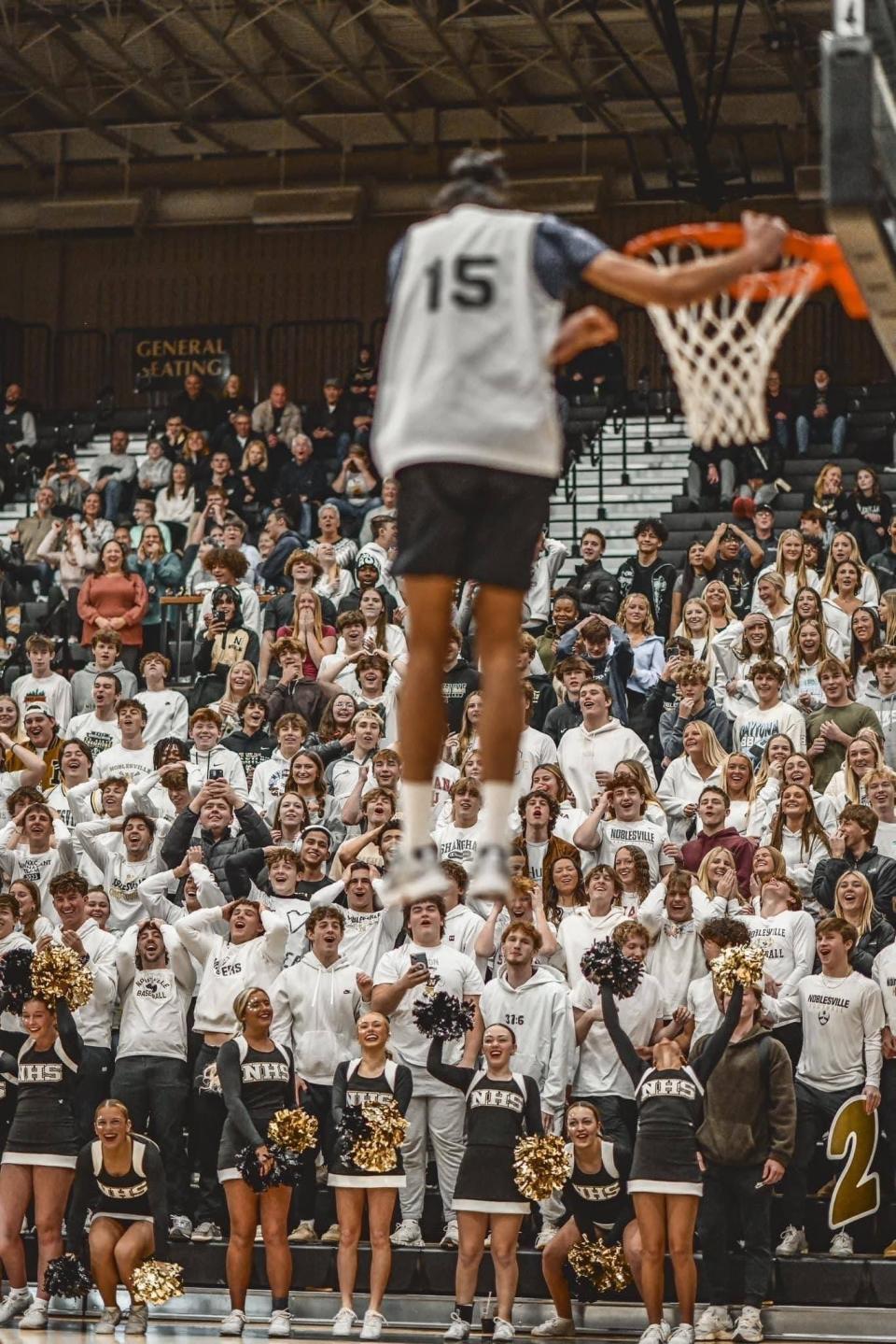 The Noblesville student section reacts as Kuljeet Mehra nearly throws down a dunk in the Millers' Unified basketball game against Westfield.