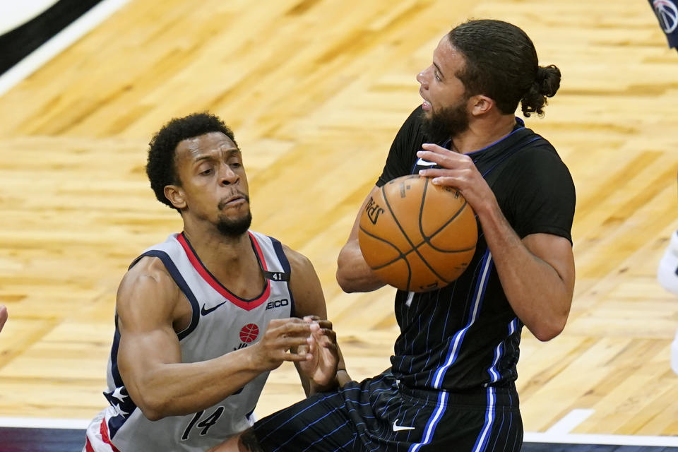 Washington Wizards guard Ish Smith, left, tries to stop Orlando Magic guard Michael Carter-Williams from shooting during the first half of an NBA basketball game Wednesday, April 7, 2021, in Orlando, Fla. (AP Photo/John Raoux)