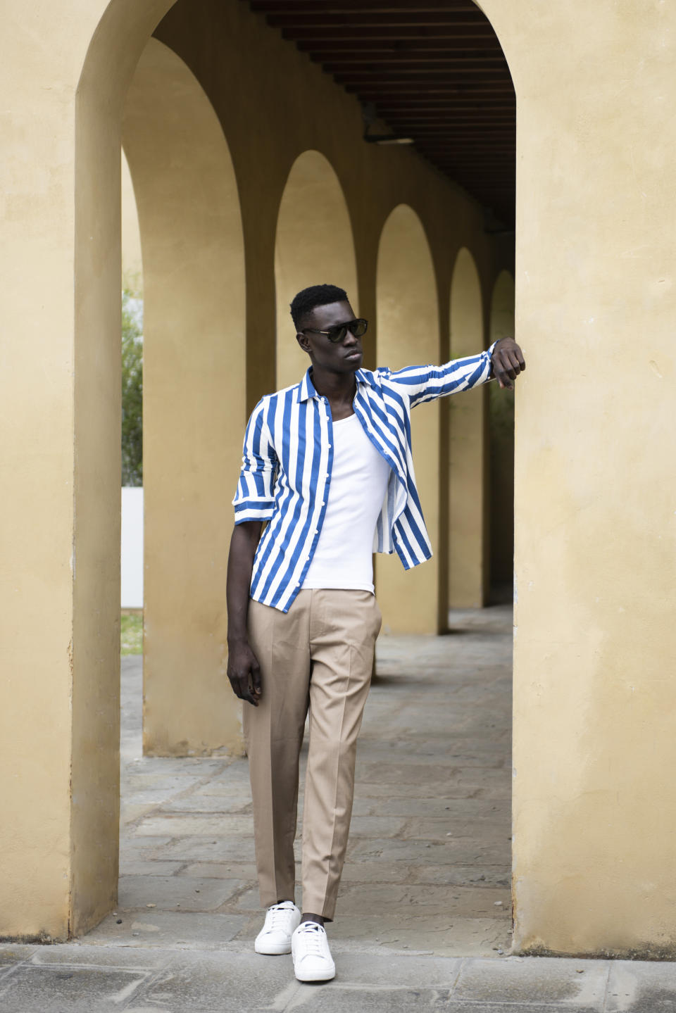 Les Garçons Faciles shirt; Cos pants; Intimissimi Uomo tank top; Tom Ford sunglasses; Paul & Shark sneakers.