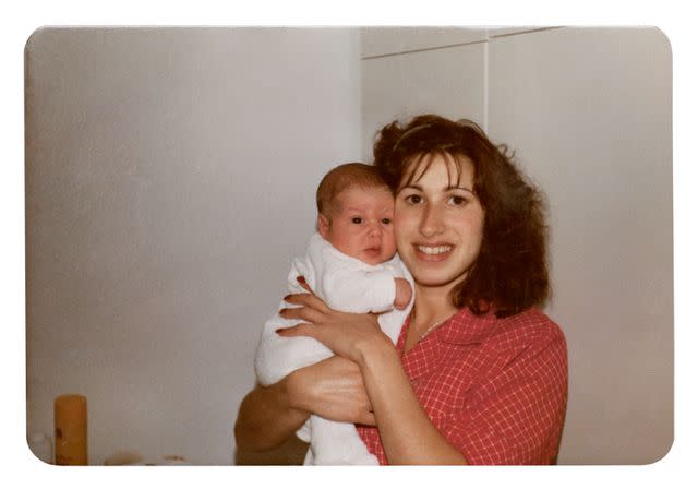 <p>Courtesy of HarperCollins</p> Amy as a baby with her mother Janis Winehouse.