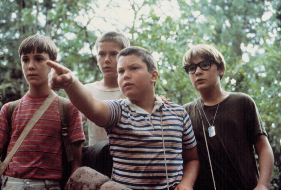 Four young boys staring at something in the woods