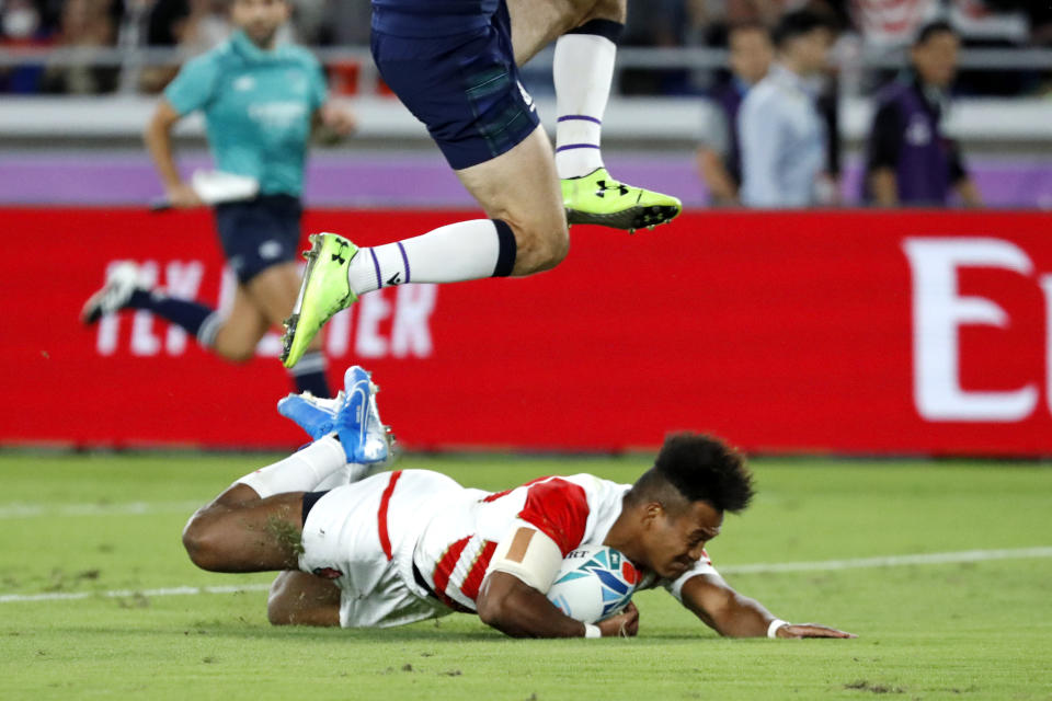 Japan's Kotaro Matsushima scores a try during the Rugby World Cup Pool A game at International Stadium between Japan and Scotland in Yokohama, Japan, Sunday, Oct. 13, 2019. (AP Photo/Eugene Hoshiko)