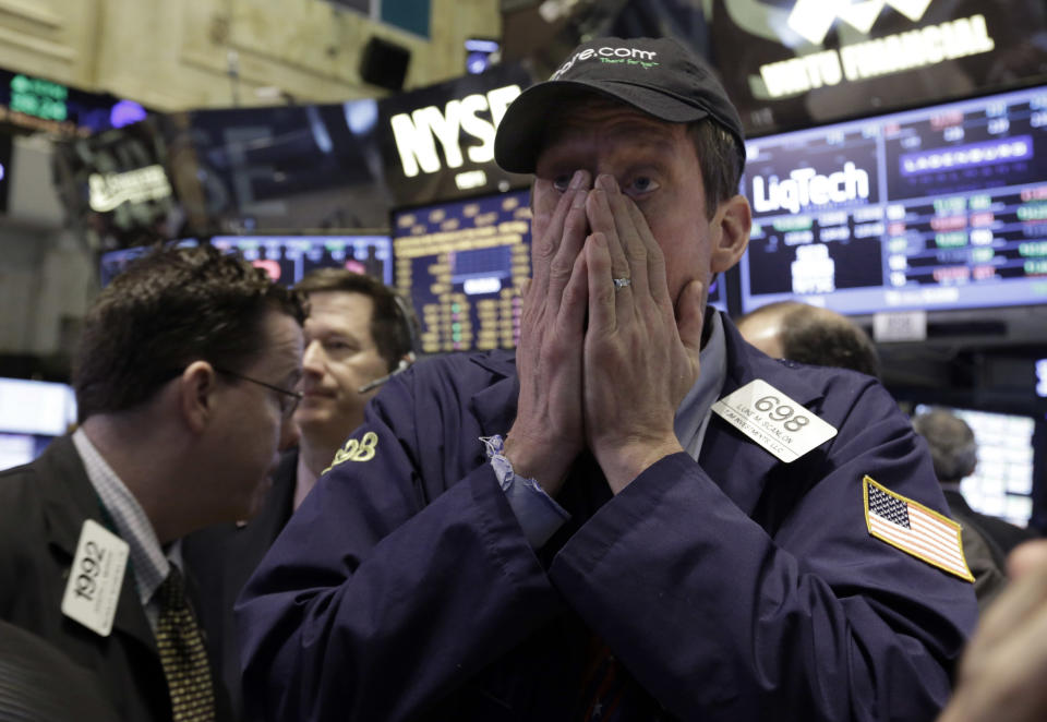 Trader Luke Scanlon works on the floor of the New York Stock Exchange Wednesday, Feb. 5, 2014. The U.S. stock market is edging lower in early trading after a modest recovery the day before. (AP Photo/Richard Drew)