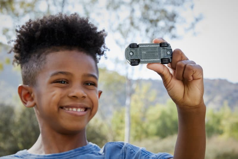 A child plays with a die-cast car