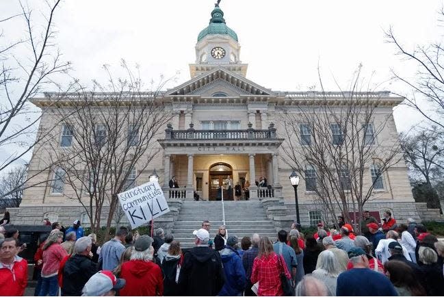 FILE - Numerous protesters gathered outside Athens-Clarke City Hall in March after the Laken Riley slaying. Athens officials recently relocated from City Hall to the Clarke County School District headquarters to conduct meetings while City Hall is refitted with better security measures.