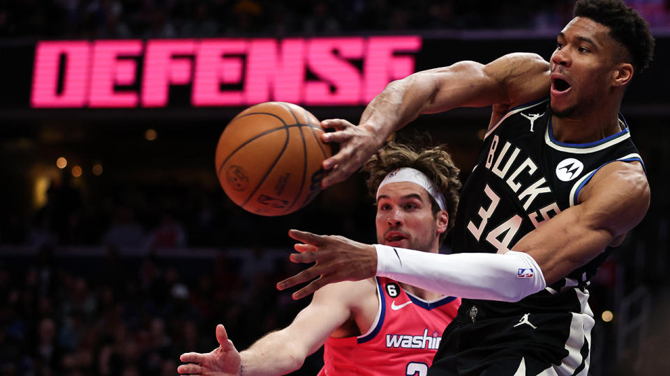 Giannis Antetokounmpo passes the ball past a Washington defender.