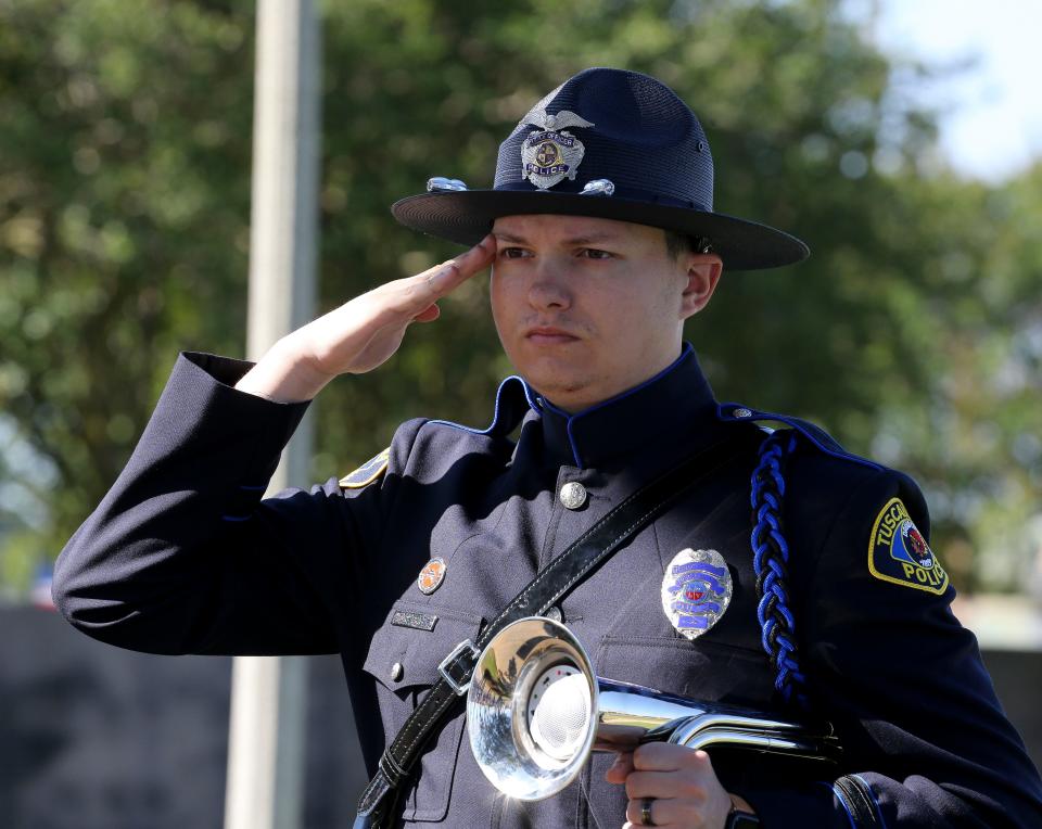 Tuscaloosa Police Honor Guard member Corporal Charlie Pierce salutes during the commemoration of  Memorial Day at Veterans Memorial Park in Tuscaloosa Monday, May 29, 2023.