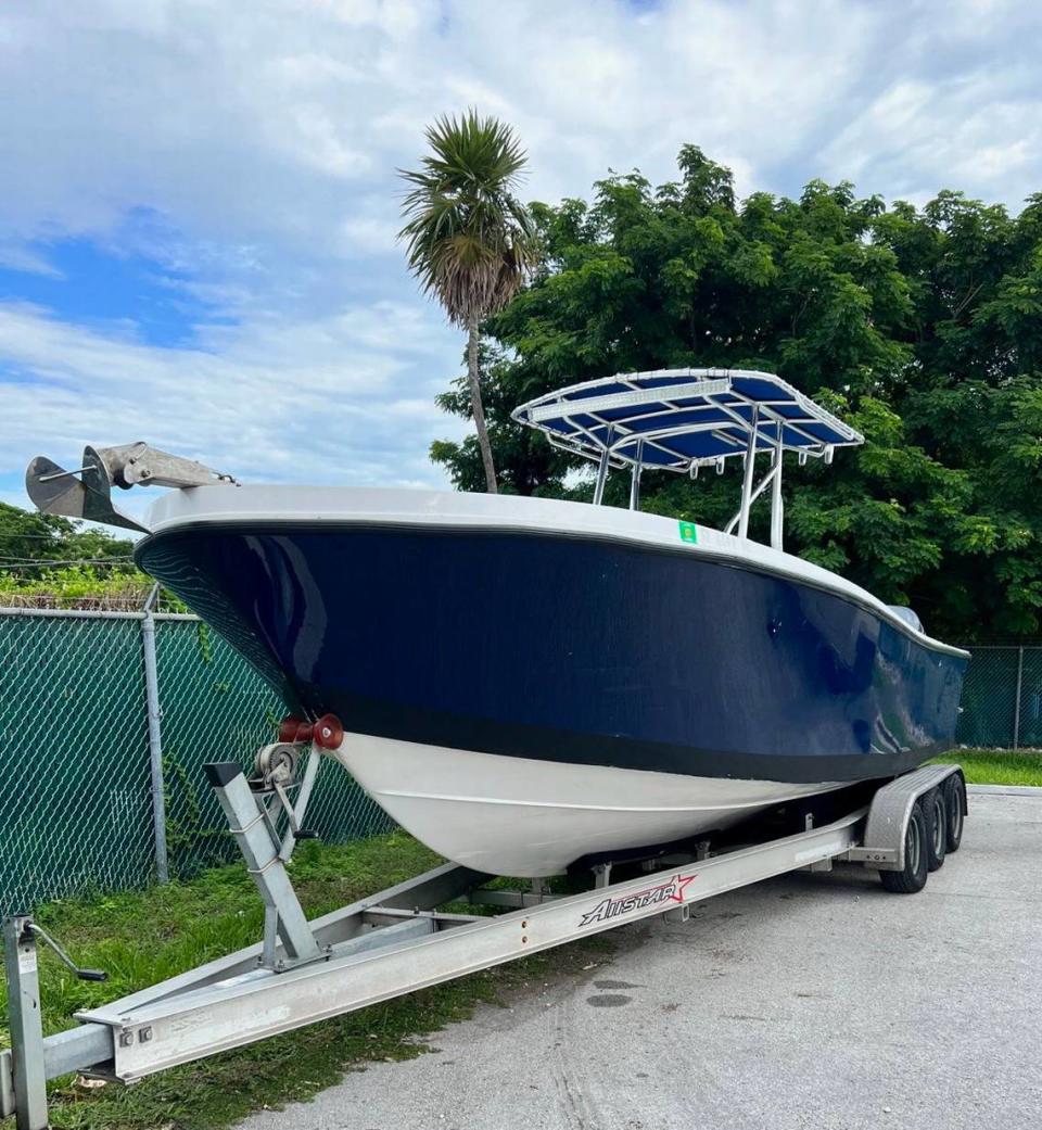 A blue and white center console boat rests on a trailer in the Florida Keys city of Marathon. The Border Patrol said it was used to smuggle 21 migrants from Cuba Thursday, Sept. 7, 2023.