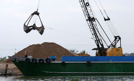 A crane moves sand from a ship on Mekong river in Hau Giang province, Vietnam December 19, 2018. Picture taken December 19, 2018. REUTERS/Kham