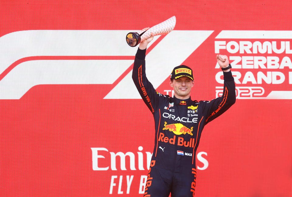 Pictured here, Red Bull's Max Verstappen celebrates with the trophy on the podium after winning the Azerbaijan Grand Prix.