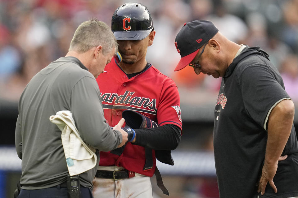 Cleveland Guardians manager Terry Francona, right, looks on as Andrés Giménez, center, is tended to after being hit with a pitch in the fifth inning of a baseball game against the Tampa Bay Rays, Saturday, Sept. 2, 2023, in Cleveland. (AP Photo/Sue Ogrocki)